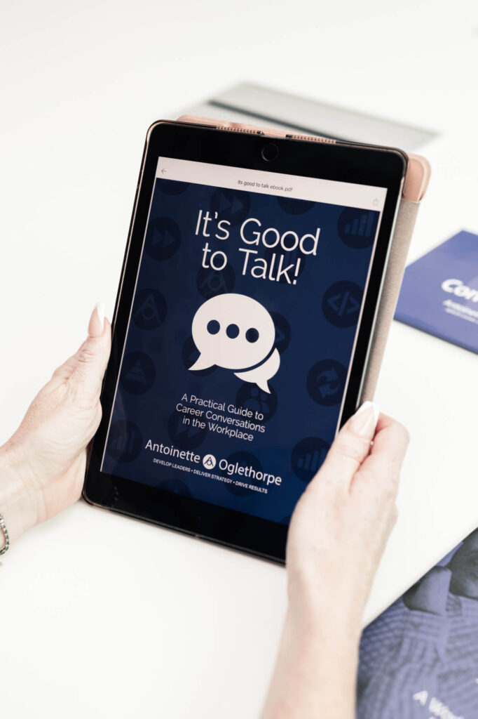 A person holds a tablet displaying an e-book cover titled 